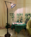 Blue Baroque Tiffany Style Stained Glass Swing Arm Floor Lamp, 75-Inch Tall with 10-Inch Shade in a cozy reading nook