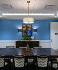 Round LED Downlight That Delivers 1500 Lumens At 3500K Neutral White illuminating a conference room with blue walls.