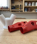 Heavy Duty Red Dust Hood For Machinery And Automatic Dust Collection Systems, red plastic connectors on workbench.