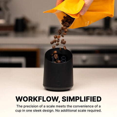 Subscale Digital Dosing Cup With LED Display Sleek Black Scale for espresso brewing, shown with coffee beans being poured in