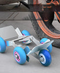 Heavy Duty Flat Tire Trolly Cart With 5 Smooth Rolling Wheels for Cars Vans or Electric Trikes on pavement next to a tire.