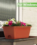 Kick It Up A Notch On Your Deck With These Sturdy Railing Planter Boxes Perfect For Balconies Patios And Windowsills Quick Setup Metal Brackets Included Deep Root Zone For Lush Greenery Classic Red Finish. Red planter box on a windowsill filled with colorful flowers.