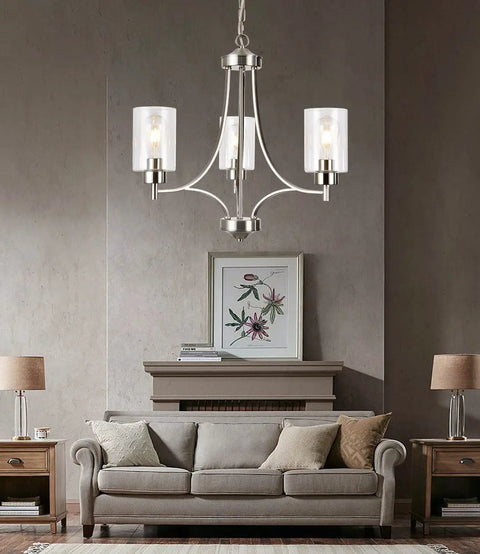 Dope 3 Light Modern Chandelier In Brushed Nickel With Clear Glass Shades above living room with beige couch and artwork
