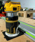 Slick Guide Rail Adapter For Trim Routers on trim router, positioned for accurate straight cuts, with metal track in background.