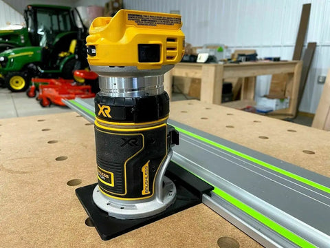 Slick Guide Rail Adapter For Trim Routers on trim router, positioned for accurate straight cuts, with metal track in background.