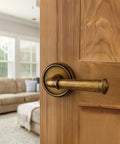 Antique Brass Passage Door Handle Lever For Interior Doors Vintage Aluminum Alloy Door Lever For Hall Closet Kitchen Pantry No Locking Required Easy Install 1 Pack installed on a wooden door.