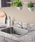 Colony Pro Single Handle Kitchen Faucet With Deck Plate In Polished Chrome, Drip Free Ceramic Disc Valve in a modern kitchen setting