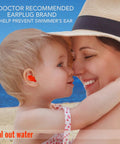 Child wearing Soft Moldable Silicone Ear Plugs For Kids Size Small Pack Of Six, comfy and waterproof, at the beach with parent.