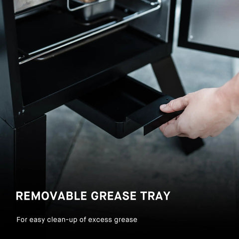 Removing the grease tray from Electric Vertical BBQ Smoker With Analog Temperature Control 30 Inch Black Unit Featuring 535 Sq In