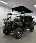 Four Seater Electric Golf Cart With 14 Inch Off Road Tires And MacPherson Strut Suspension in a showroom setting.