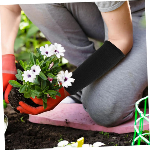 Person using Heavy Duty Thorn Protective Arm Sleeves Cut Resistant Guard For Farm Chores And Yard Work while planting flowers.