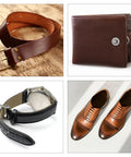Leather belt, wallet, watch with band, and shoes arranged in a grid pattern on a surface.