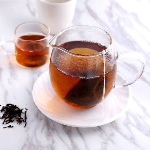 400 Count Disposable Tea Filter Bags With Drawstring For Loose Leaf Tea Unbleached Natural Paper 7 By 9 Cm Your Go To Tea Infusers For Travel Mugs And Quick Brew in a glass teapot