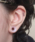 Person wearing 10G Clear Silicone Ear Gauges Tunnels Plugs Retainer Set Four Pairs Ultra Thin Soft Flexible Double Flared Saddle Piercing Jewelry