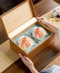 Top Shelf Slick Ceramic Tea Canister Set Featuring Sealed Lids For Loose Leaf Tea Coffee Beans Spices And Easy Pantry Organization Stylish Multi Jar Vessel For Home Use in a wooden box with a decorative spoon.