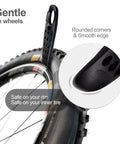Close-up of Ultra Strong Bicycle Tire Levers Set, showing black lever lifting bike tire, smooth edges, compact roadside repair kit.