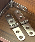 Six Piece Folding Door Hinges Set With Rust Resistant Finish Heavy Duty And Easy Install For Furniture And Decor Bulletproof Build Iron Construction 7.8 By 1.7 Cm Great For Cabinets Doors And DIY Projects displayed in a wooden cabinet corner.