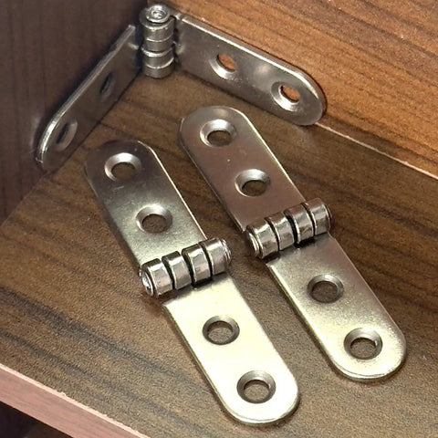 Six Piece Folding Door Hinges Set With Rust Resistant Finish Heavy Duty And Easy Install For Furniture And Decor Bulletproof Build Iron Construction 7.8 By 1.7 Cm Great For Cabinets Doors And DIY Projects displayed in a wooden cabinet corner.
