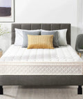 Bedroom with gray upholstered bed, white mattress, and adjustable furniture feet for stability.