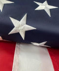 Close-up of Heavy Duty Outdoor US Flag 2.5x4 Ft with embroidered stars and sewn stripes, showing durable stitching and vivid colors.