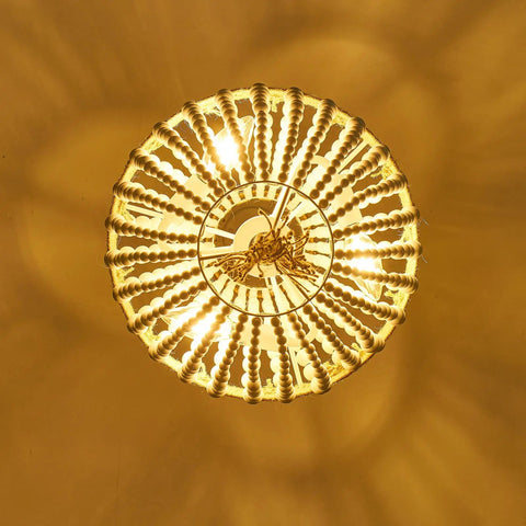 Top view of Boho Wood Beaded Pendant Light with E12 Ball Bulbs, showing warm glow and intricate ivory white bead detailing.