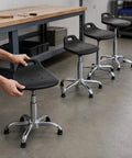 Built Tough Antistatic Shop Stool Height Adjustable Rolling Work Seat With Swivel Casters For Cleanrooms And Assembly Lines in a workshop setting.