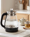 1 Liter Glass Electric Kettle With Keep Warm Function, Rapid Boil Tech, Auto Shut Off Safety, Bpa-Free Borosilicate Build, And An Easy Pour Spout For Your Daily Must Have Morning Routine on a kitchen countertop.