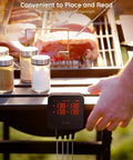 User adjusting WiFi Meat Thermometer With 4 Probes on a grill, displaying multiple temperatures for cooking steaks.