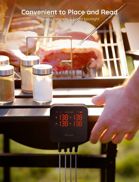 User adjusting WiFi Meat Thermometer With 4 Probes on a grill, displaying multiple temperatures for cooking steaks.