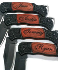 Four personalized engraved pocket knives with rosewood handles and names, featuring steel blades and intricate designs.