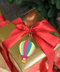 Unfinished Wooden Hot Air Balloon Cutouts With Twine, 20 Pieces, DIY Blank Ornaments on gift box with red ribbon