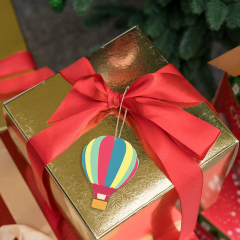 Unfinished Wooden Hot Air Balloon Cutouts With Twine, 20 Pieces, DIY Blank Ornaments on gift box with red ribbon