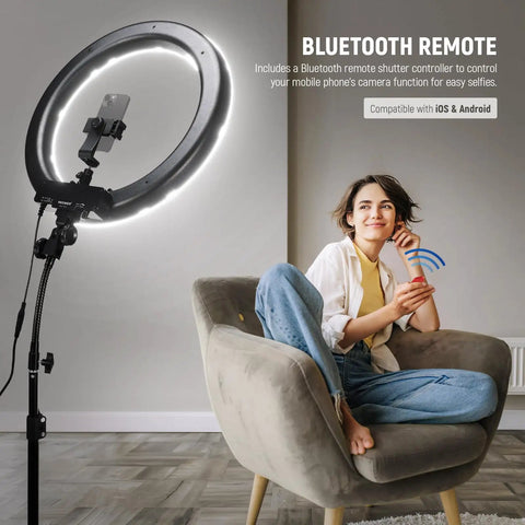 18 Inch Ring Light Kit With 55W 5600K Pro LED Stand Phone, woman using remote control in modern studio setting.