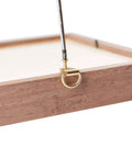 Wooden frame with a brass D-ring, part of the DIY Picture Hanging Hardware Kit 220 Piece Brass Finish Set, holding steel wire.