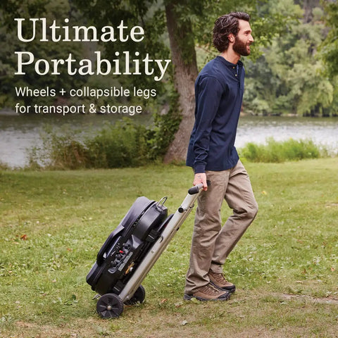 Person rolling the RoadTrip 285 Portable Stand Up Propane Grill With 3 Adjustable Burners Instastart Ignition 20000 BTUs