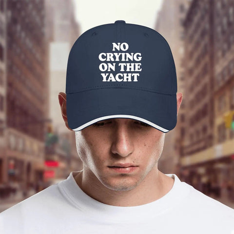 Person wearing No Crying On The Yacht Baseball Hat For Dad Navy, Adjustable Strap Cap in city street background.