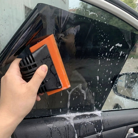 Applying tint film using squeegee from All-In-One Vinyl Wrap Heat Gun Kit For Cars And Window Tinting, 1800W 110V Hot Air Tool.