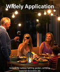 People enjoying dinner with Solar Outdoor Lanterns Waterproof 14 Inch Two Pack With LED Flickering Flameless Candles on the table.