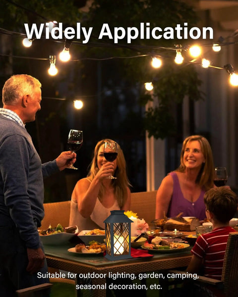 People enjoying dinner with Solar Outdoor Lanterns Waterproof 14 Inch Two Pack With LED Flickering Flameless Candles on the table.
