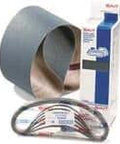 Sandpaper roll, packaged belts, and boxed industrial maintenance products on a plain background