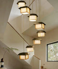 Massive Staircase Chandelier With Eight Bamboo Shades And Long Adjustable Drop serving serious retro country vibes in a modern entryway.