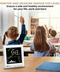 Top Shelf CO2 Monitor For Home Air Quality Tracker Measuring Real Time Temperature Humidity Levels With Photoacoustic Sensor on classroom desk.