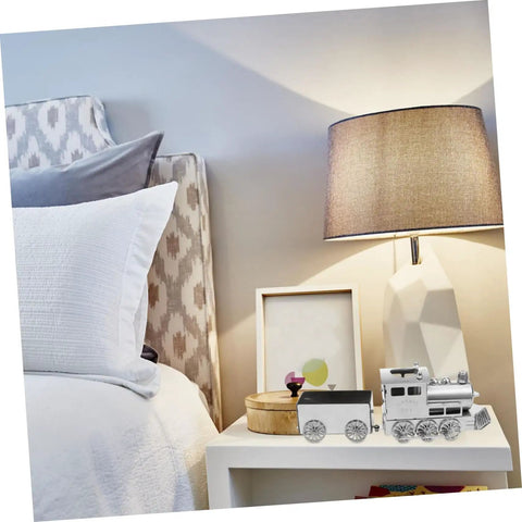 Retro Steam Locomotive Desk Decor for Home Office, silver model on a nightstand next to a lamp and framed photo