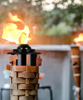 Close-up of torch replacement canisters for bamboo lanterns, refillable outdoor torches, yard patio deck garden party decor, 16oz 6 pack.