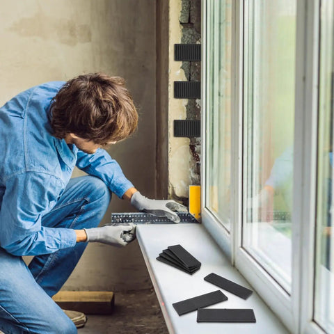 Person using Solid Plastic Shim Set For Leveling And Drywall Applications, 80 Pieces In 3/64 5/64 1/8 And 5/32 Inch Black indoors