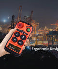 Front view of Q400 industrial crane remote control in bright orange with four black buttons, handheld.