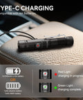 1400 Lumen Right Angle EDC Flashlight Headlamp charging via USB-C on leather surface