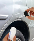 Applying paint with 6 Pack Empty Touch Up Paint Bottles 2 Oz Refillable Containers With Brush Applicator for car scratch repair.