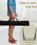 Man carrying 2 In 1 Outdoor Hammock With Stand Hangout Ready Swing Chair Portable Heavy Duty Steel Frame Backyard Vibe in carry bag