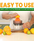 Primtronic Electric Citrus Juicer With Large 24 Oz Capacity And Seed Filter Auto Reverse Function Compact Design For Oranges Lemons Limes BPA Free Black Orange in use with fresh citrus.
